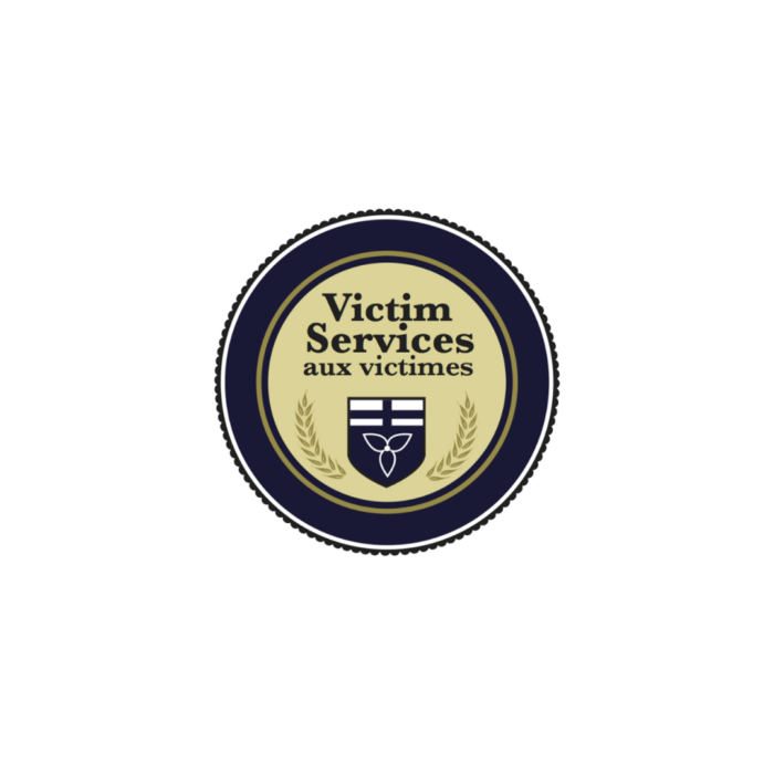 Timmins Care Logo of Victim Services with a blue, circular border, a shield in the center, and text reading "Victim Services aux victimes. Cochrane District Social Services Administration Board